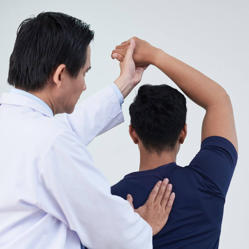Physiotherapist working on back of man