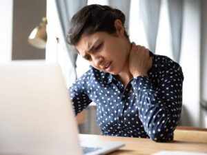 Woman with stiff neck from using laptop